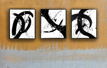 Monochrome abstract painting set of three framed canvases with sweeping strokes and arcs.
