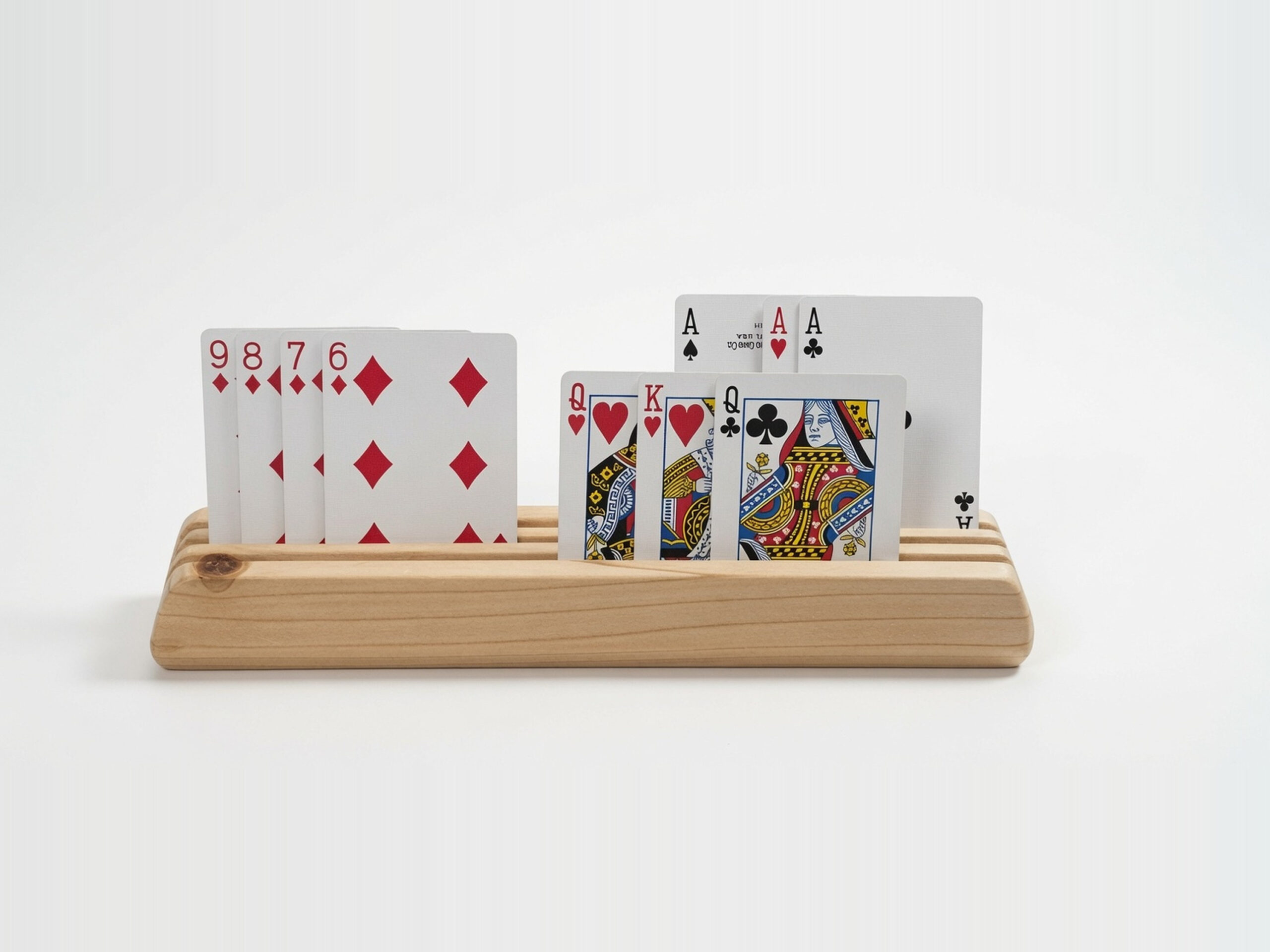 Front view of a wooden playing card holder made from fir, with face-up cards visible in three tiered rows.