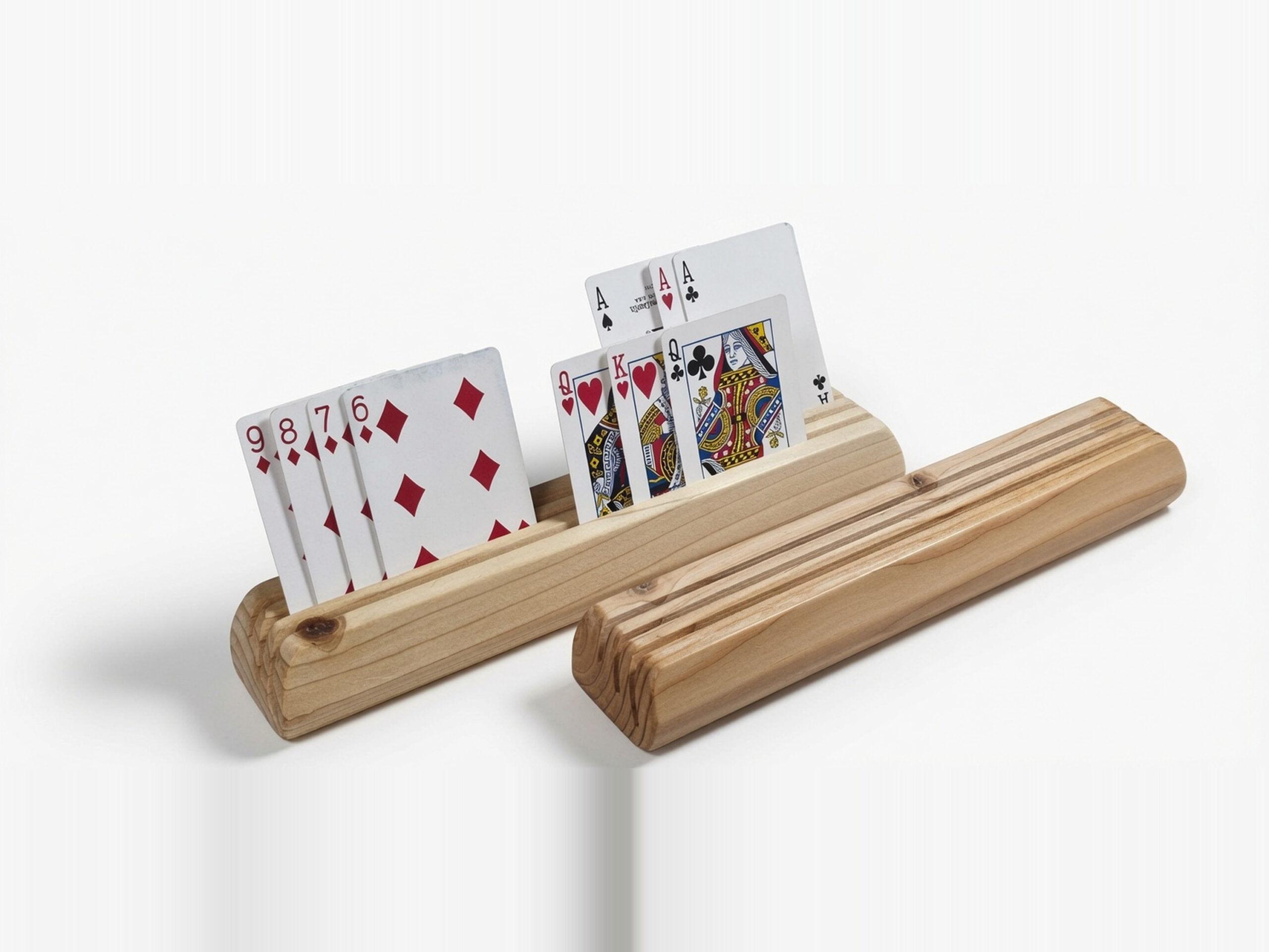 Two wooden playing card holders made from fir on a white background, one holding face-up cards and one empty to show the three-slot construction.